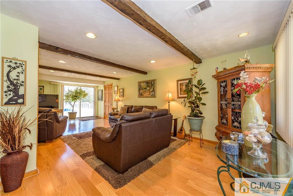 141 Devon Road Colonia, NJ 07067 - Photo 4 of 25 a living room with furniture and a flat screen tv