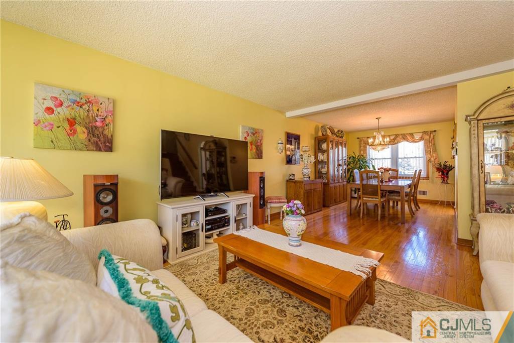 141 Devon Road Colonia, NJ 07067 - Photo 7 of 25 a living room with furniture and a flat screen tv