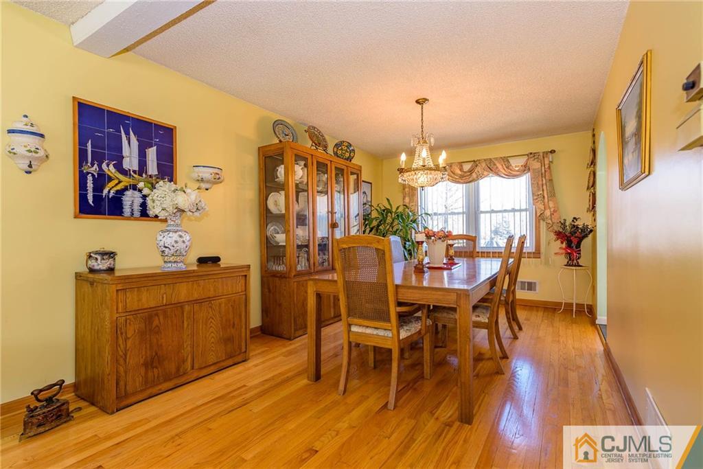 141 Devon Road Colonia, NJ 07067 - Photo 8 of 25 a dining room with furniture and wooden floor