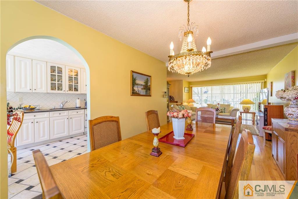 141 Devon Road Colonia, NJ 07067 - Photo 9 of 25 a view of a dining room with furniture and chandelier