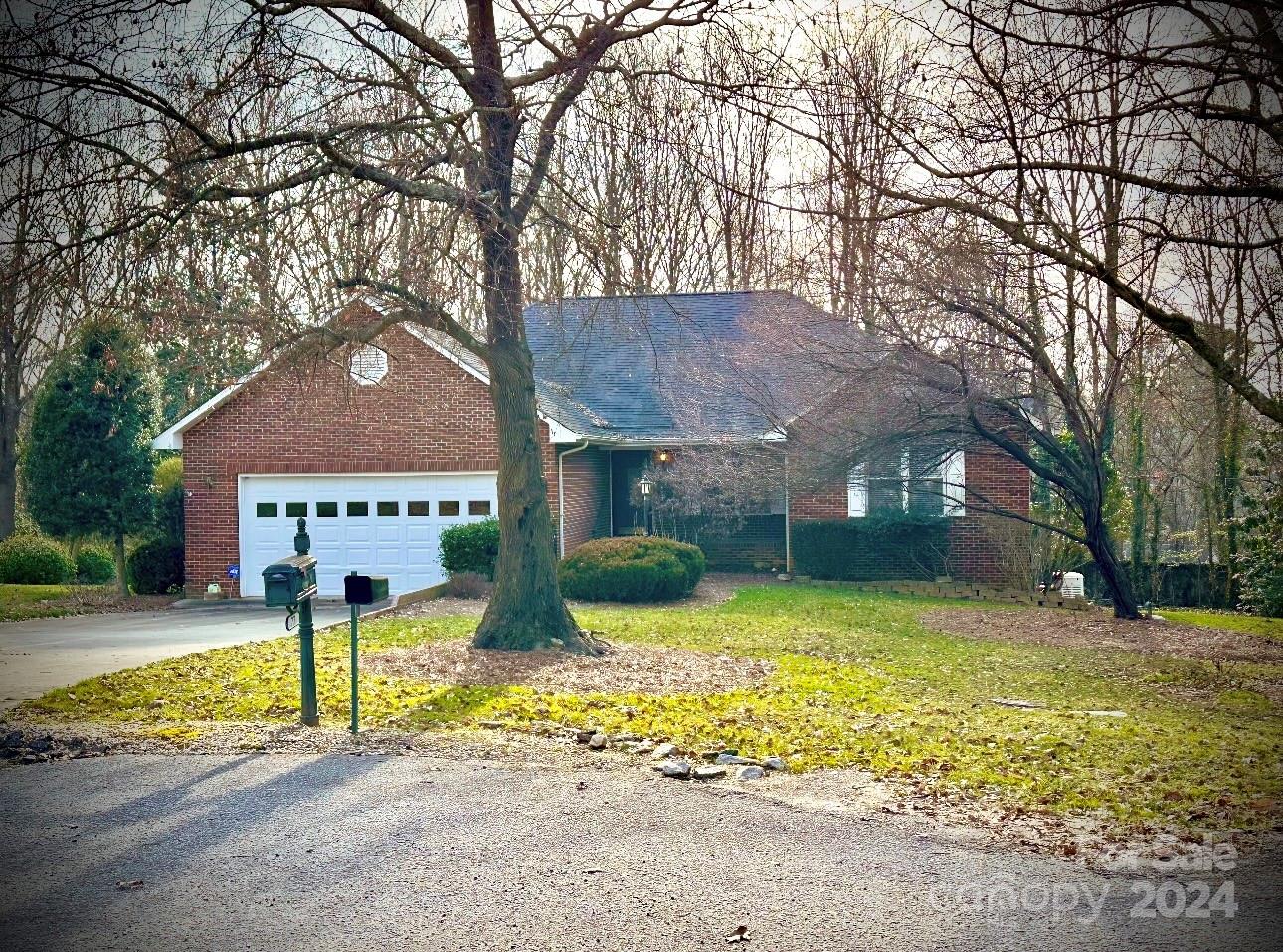 a front view of a house with yard and garage