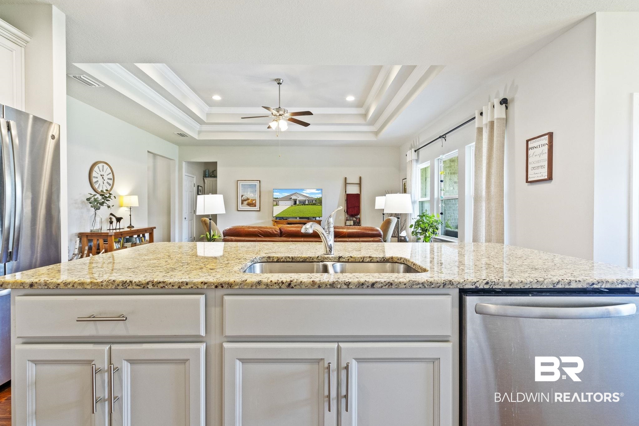 31663 Kestrel Loop Daphne, AL 36527 - Photo 24 of 86 Kitchen with white cabinets, ceiling fan, stainless steel appliances, and a raised ceiling