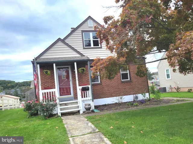 a view of a house with a yard and sitting area