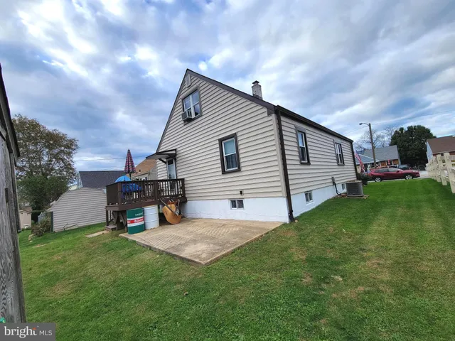 a car parked in front of a house with a yard