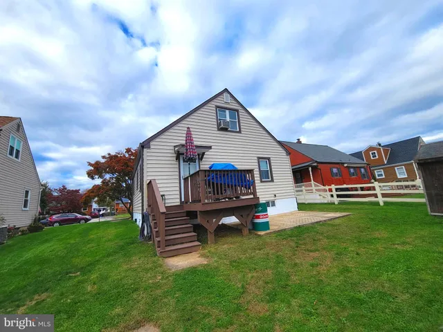 a view of a house with a yard and a deck