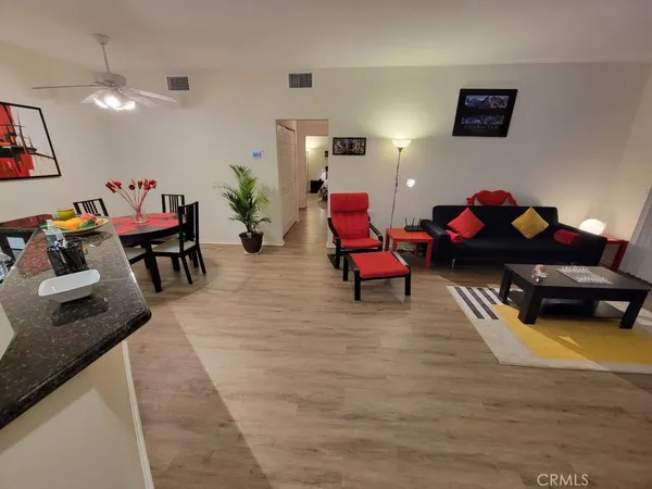 a living room with furniture and a wooden floor