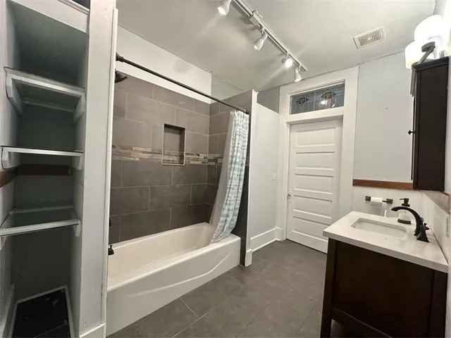 a bathroom with a sink toilet and mirror