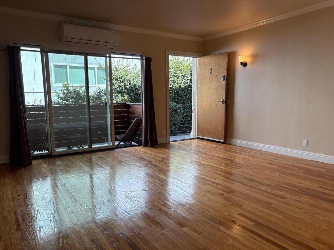 11719 Mayfield Avenue, Unit 1 Los Angeles, CA 90049 - Photo 11 of 28 an empty room with wooden floor and windows