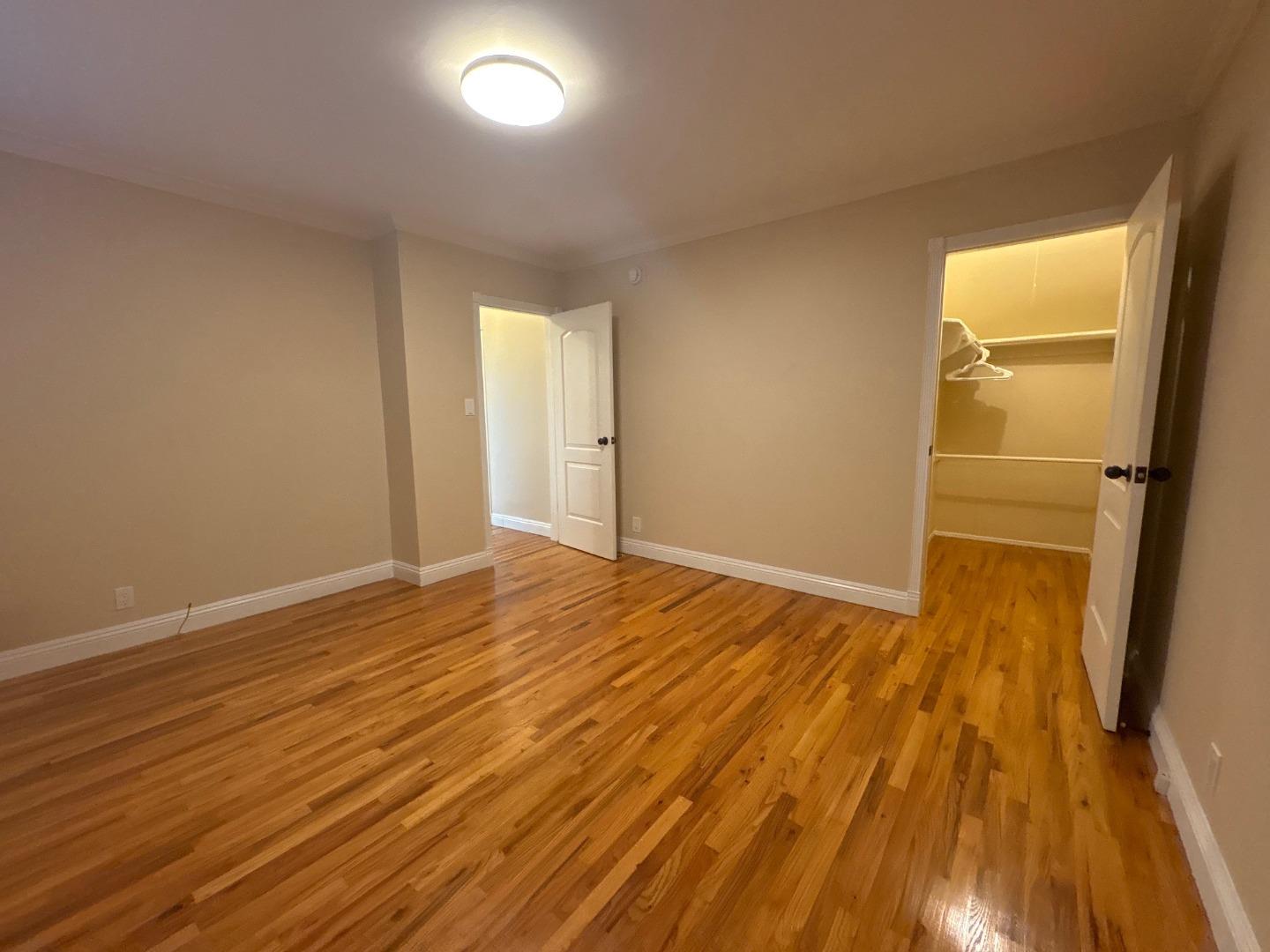 11719 Mayfield Avenue, Unit 1 Los Angeles, CA 90049 - Photo 21 of 28 a view of empty room with wooden floor and fan