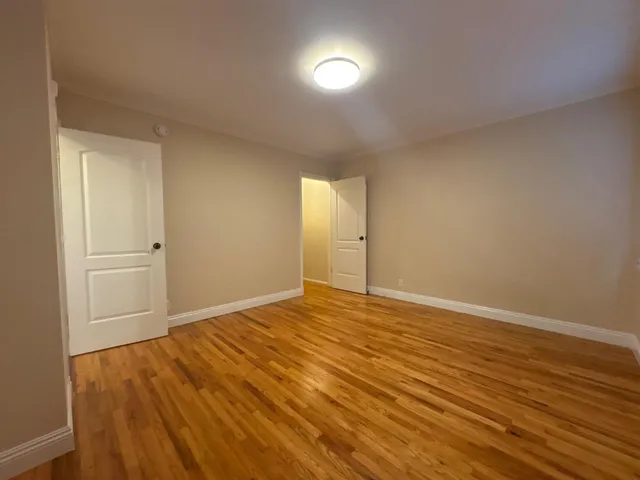 a view of an empty room and wooden floor
