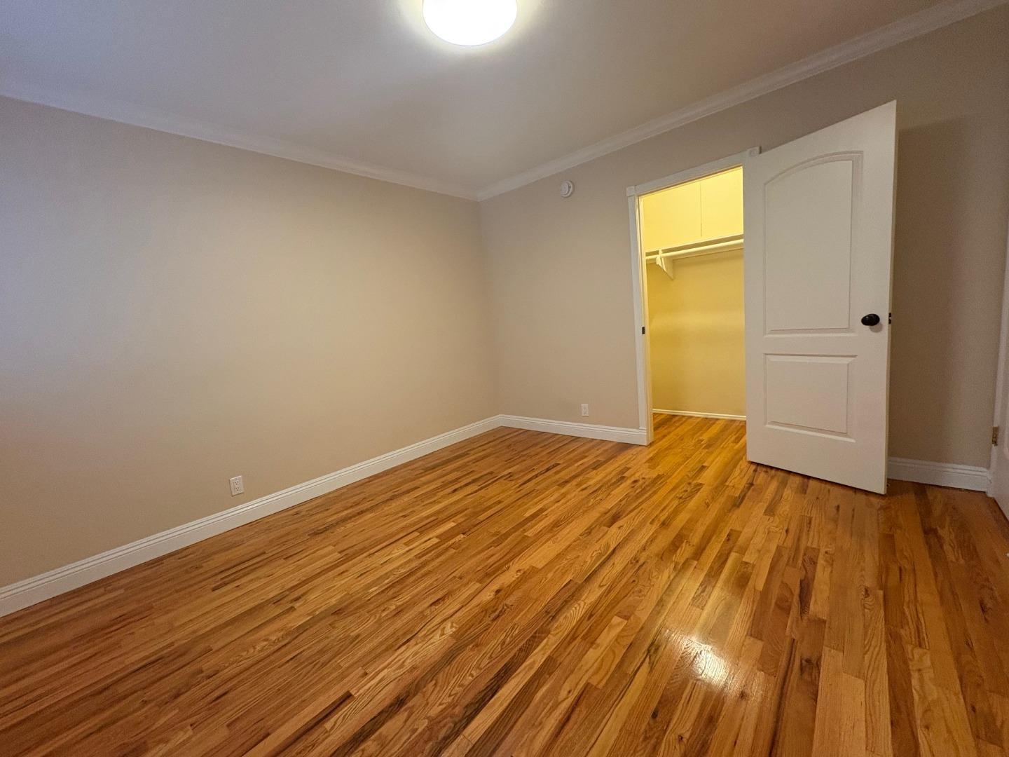 11719 Mayfield Avenue, Unit 1 Los Angeles, CA 90049 - Photo 25 of 28 a view of empty room with wooden floor and fan