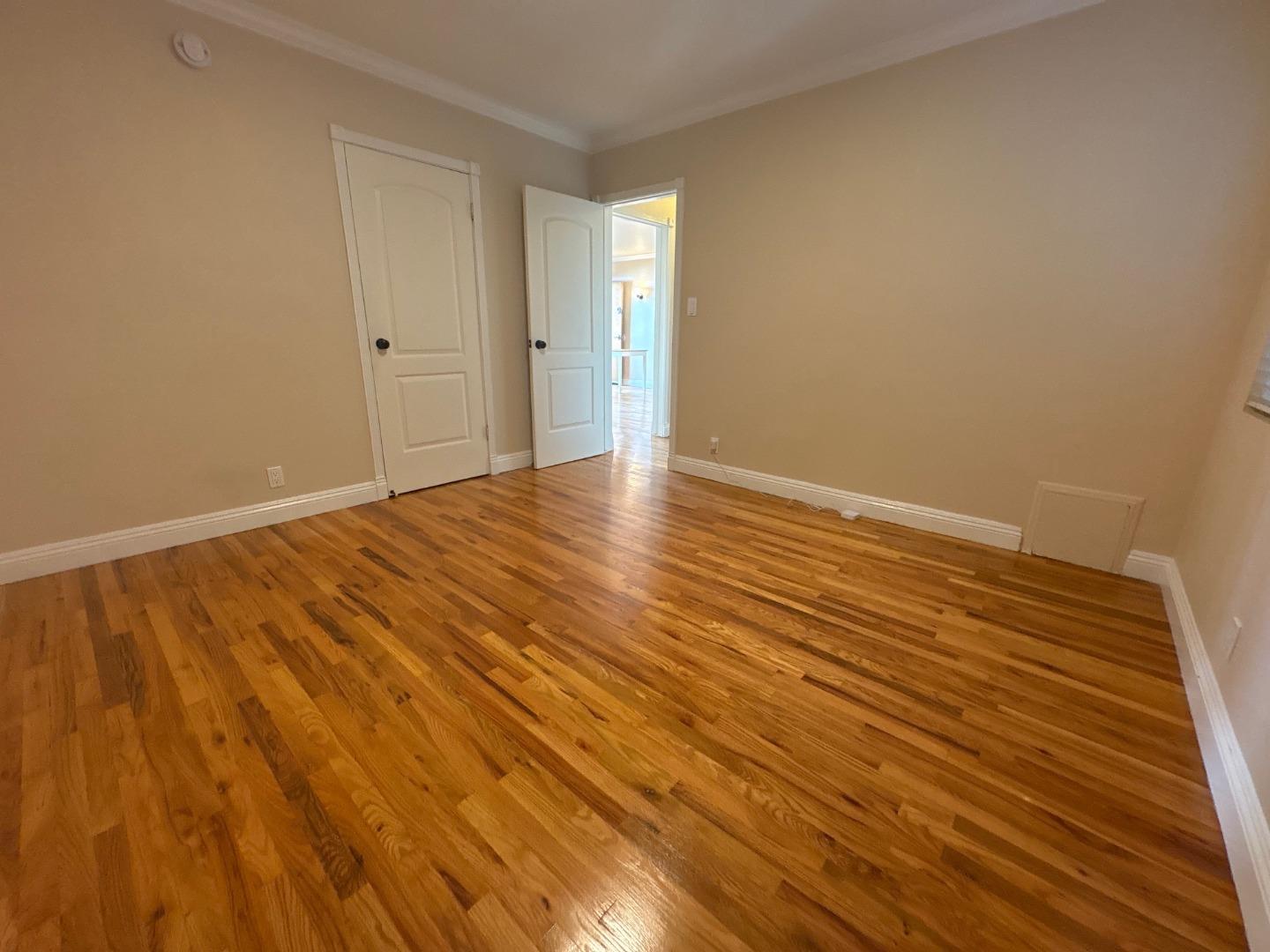 11719 Mayfield Avenue, Unit 1 Los Angeles, CA 90049 - Photo 27 of 28 a view of an empty room with wooden floor and a window