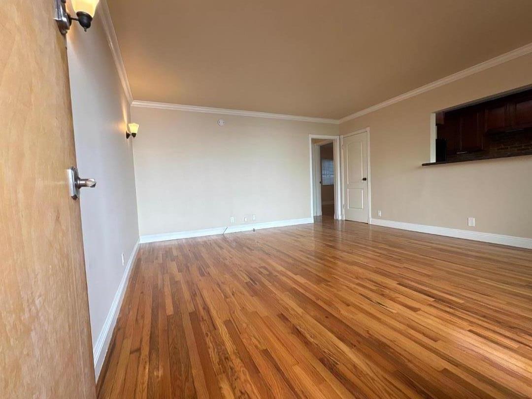 11719 Mayfield Avenue, Unit 1 Los Angeles, CA 90049 - Photo 8 of 28 a view of a livingroom with wooden floor