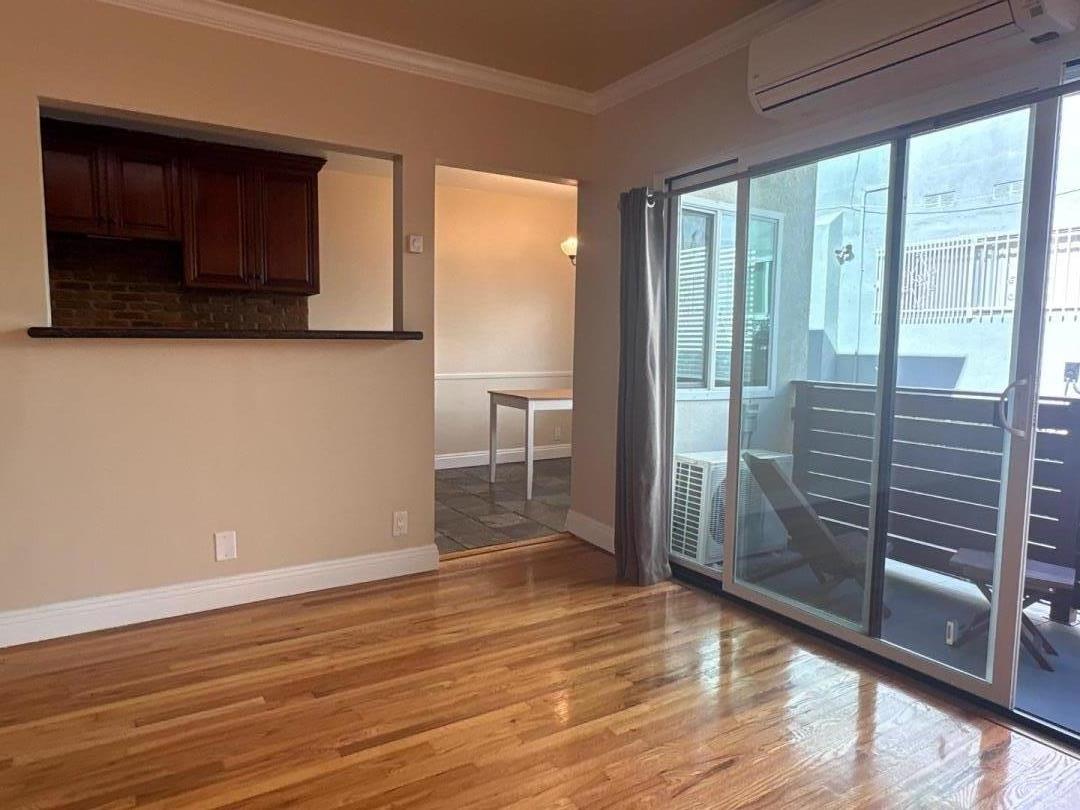 11719 Mayfield Avenue, Unit 1 Los Angeles, CA 90049 - Photo 9 of 28 a view of empty room with wooden floor and fan