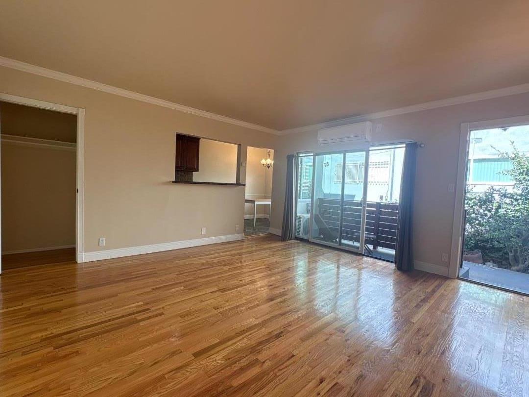 11719 Mayfield Avenue, Unit 1 Los Angeles, CA 90049 - Photo 10 of 28 a view of an empty room with wooden floor and a window