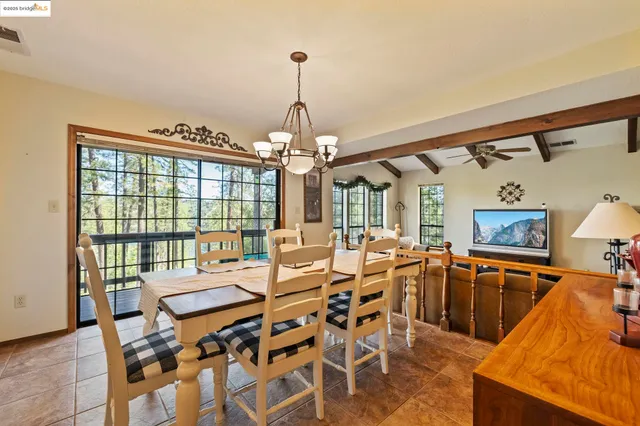 a kitchen with a table chairs microwave and cabinets