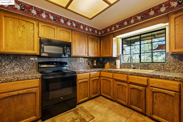 a kitchen with a table chairs refrigerator and cabinets