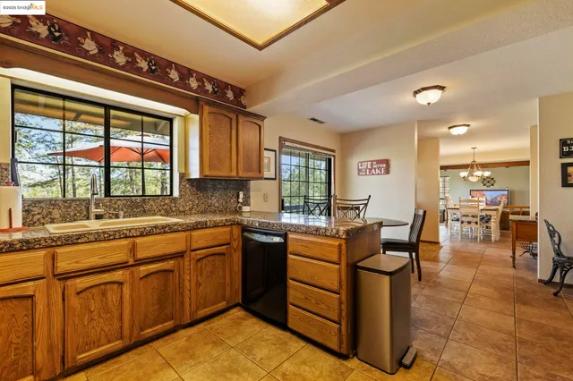 a dining room with furniture and a floor to ceiling window