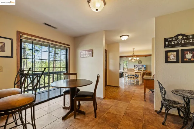 a living room with furniture a flat screen tv and a floor to ceiling window