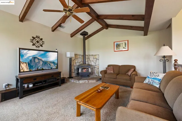 a bathroom with a granite countertop sink and a toilet