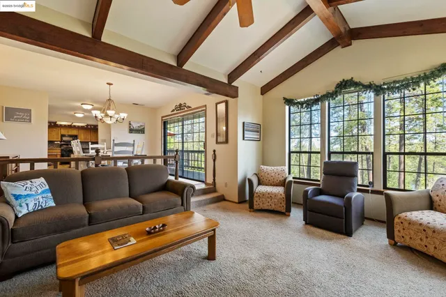 a spacious bedroom with a bed and a chandelier