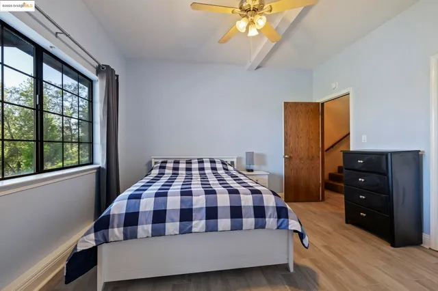 a room with pool table and windows