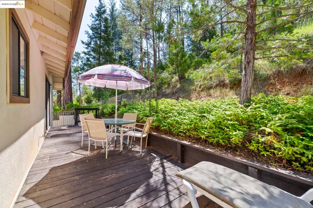 an aerial view of residential house with outdoor space and trees all around