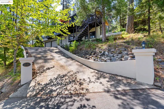 a view of a patio with a table chairs and a umbrella