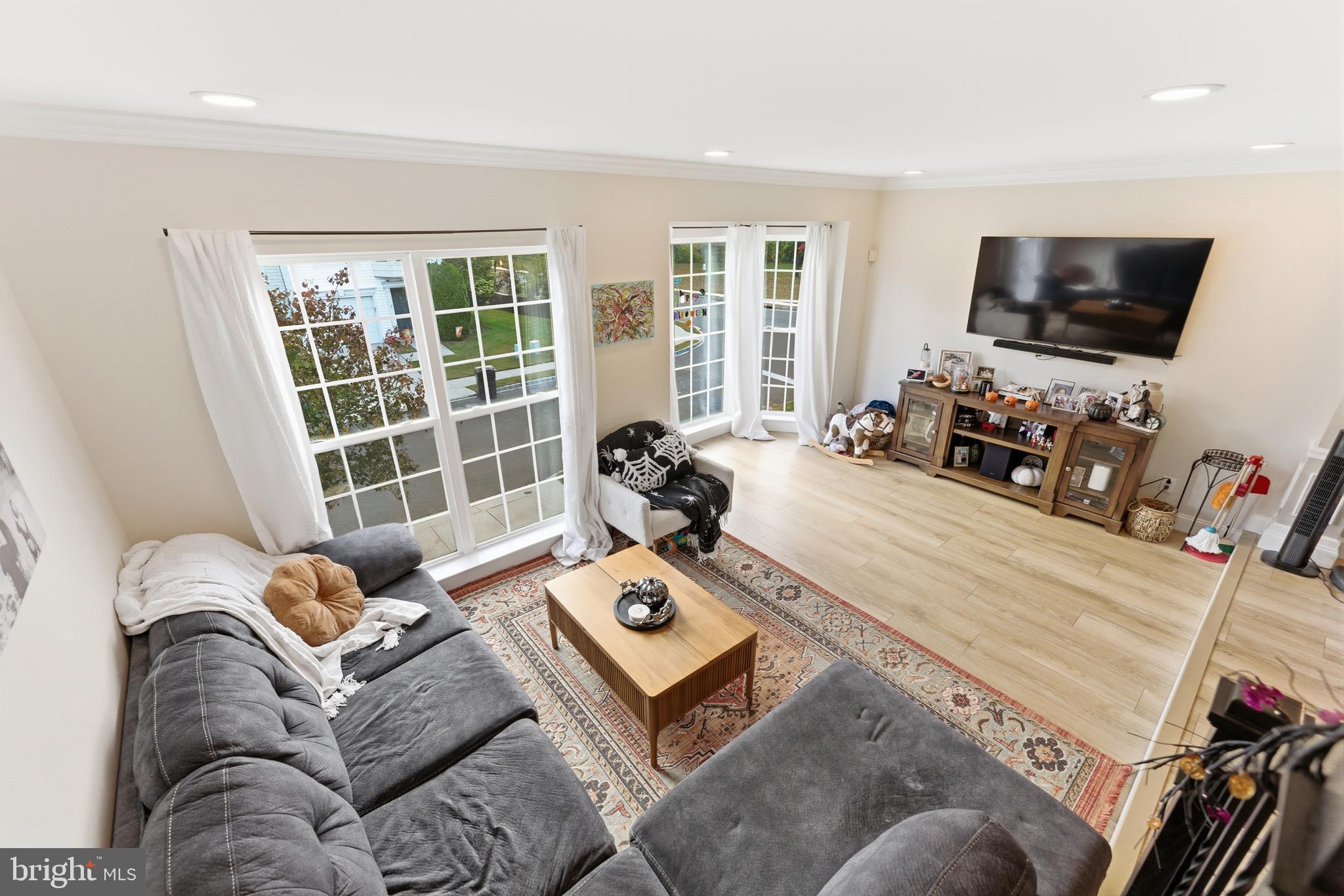 1 Weatherly Road Delran, NJ 08075 - Photo 12 of 32 a living room with furniture a flat screen tv and a large window