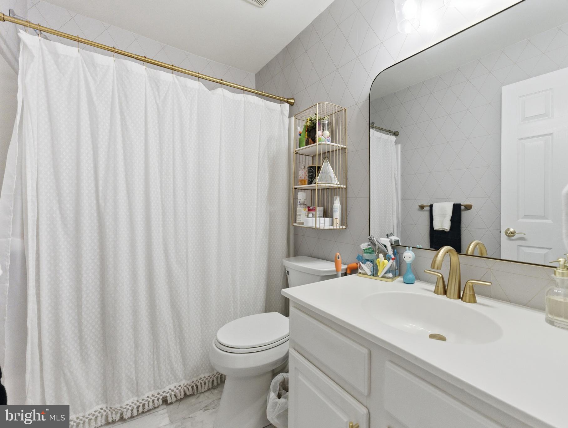 1 Weatherly Road Delran, NJ 08075 - Photo 25 of 32 a bathroom with a sink a toilet and shower curtain
