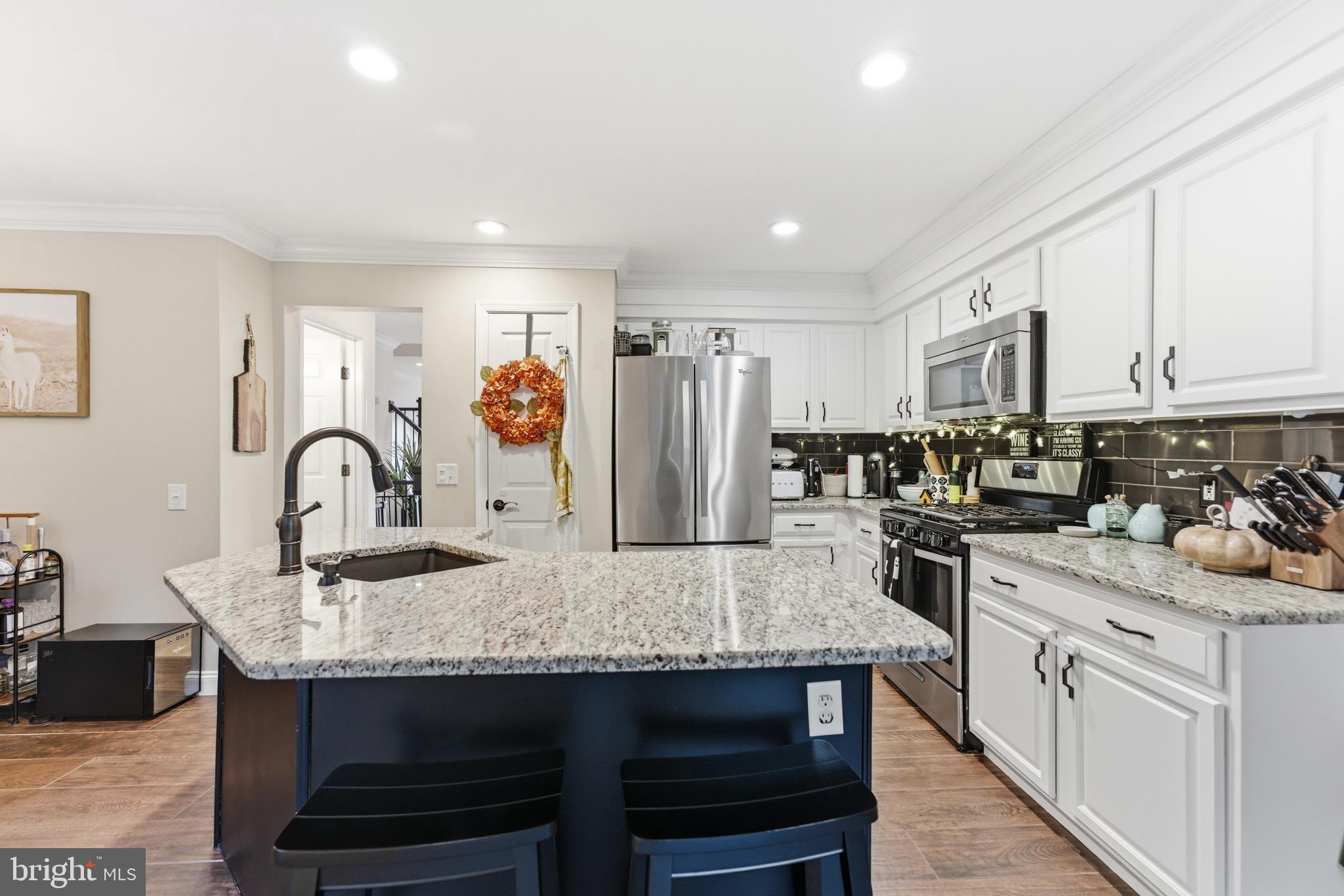1 Weatherly Road Delran, NJ 08075 - Photo 5 of 32 a kitchen with stainless steel appliances granite countertop a table chairs in it and white cabinets