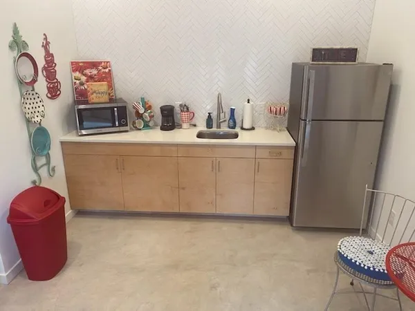 a bathroom with a sink and a refrigerator