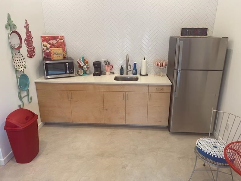 1417 Highland Boulevard St. Augustine, FL 32084 - Photo 4 of 8 a bathroom with a sink and a refrigerator