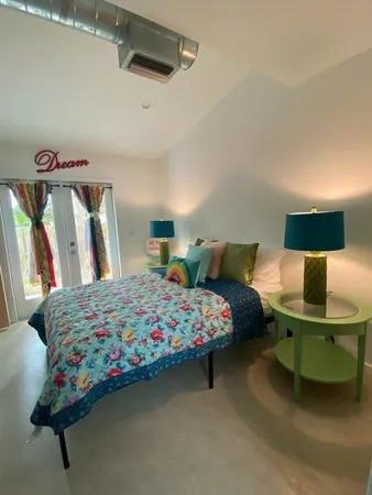 a bedroom with a bed and window