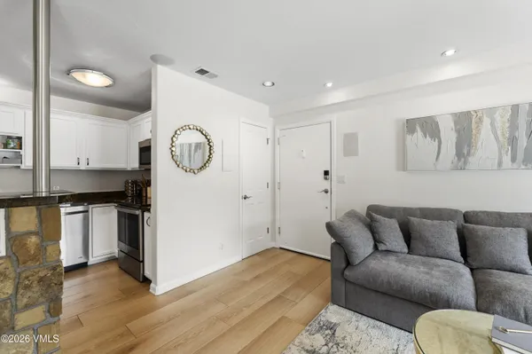 a living room with furniture and wooden floor
