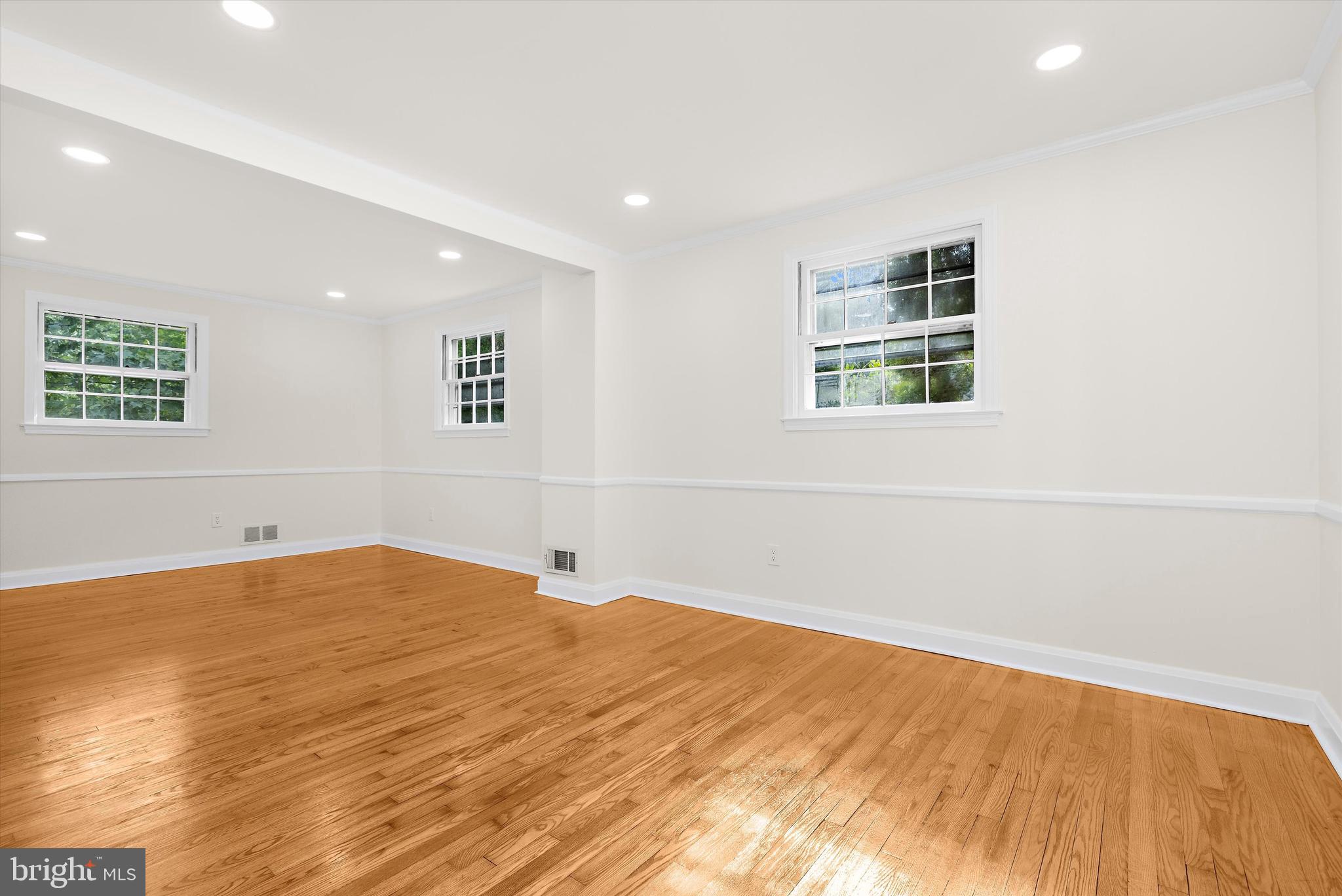 2301 Pickwick Road Baltimore, MD 21207 - Photo 8 of 50 a view of an empty room with wooden floor and a window