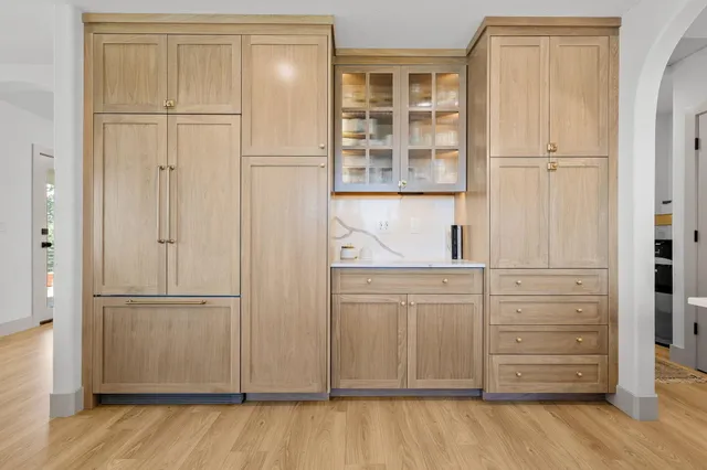 a large kitchen with a table and chairs