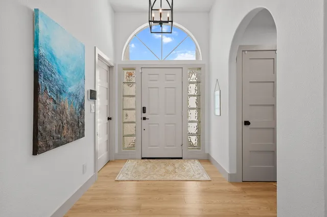 a living room with furniture and a chandelier