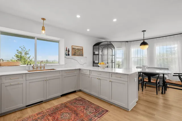 a kitchen view with dining table and chairs