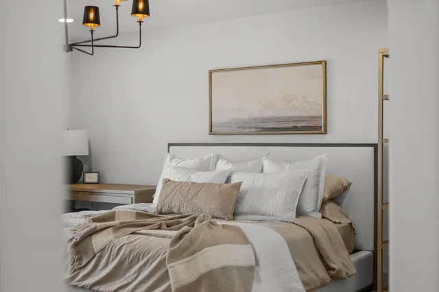 a bedroom with a bed and a television