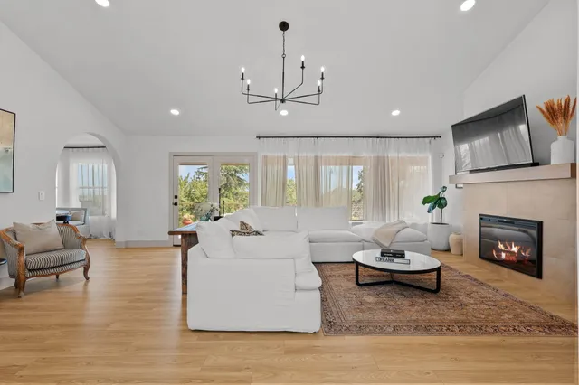 a living room with furniture a fireplace and a flat screen tv