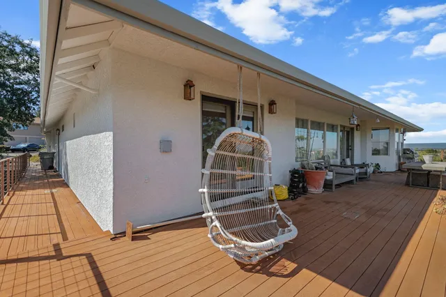 a view of a yard with plants and wooden fence