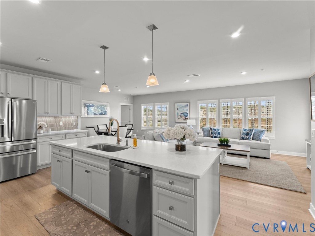 a kitchen with counter top space appliances and windows