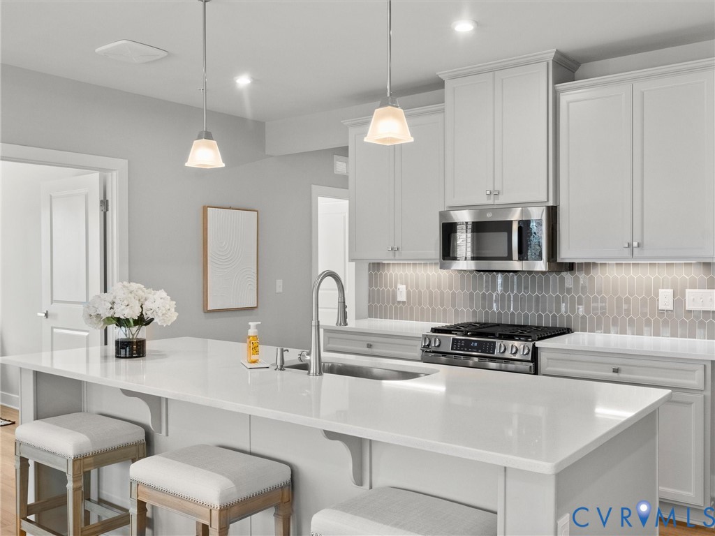 6725 Citory Way, Unit 202 Moseley, VA 23120 - Photo 12 of 42 a kitchen with stainless steel appliances a sink and a white cabinets