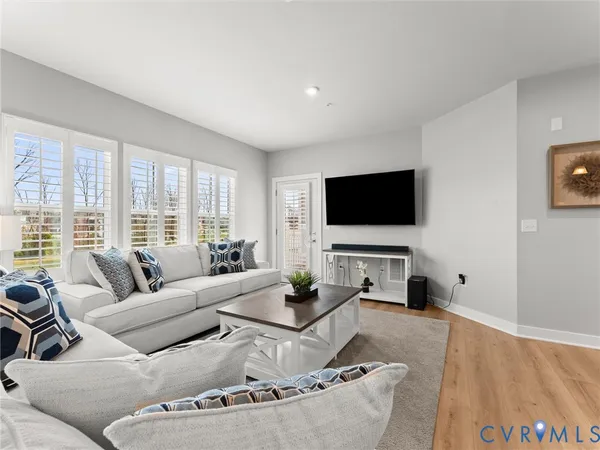a living room with fireplace furniture and a flat screen tv