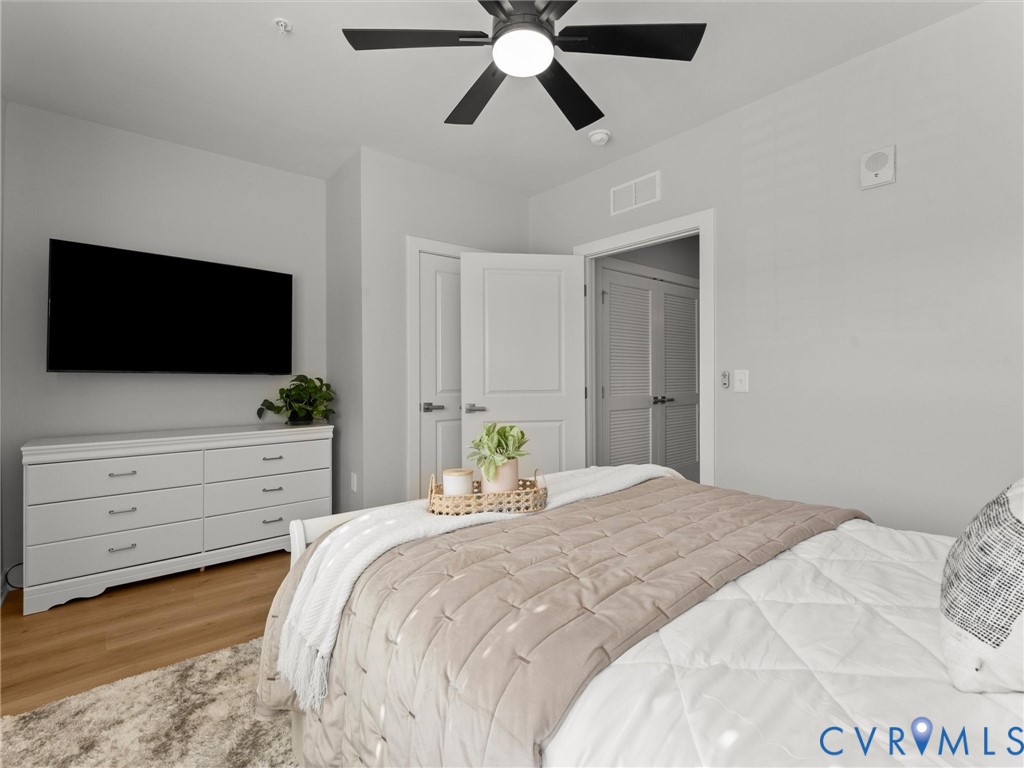 6725 Citory Way, Unit 202 Moseley, VA 23120 - Photo 30 of 42 a bedroom with a bed and a flat screen tv