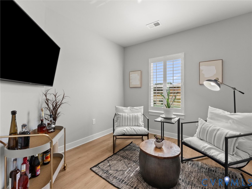 6725 Citory Way, Unit 202 Moseley, VA 23120 - Photo 35 of 42 a living room with furniture and a potted plant