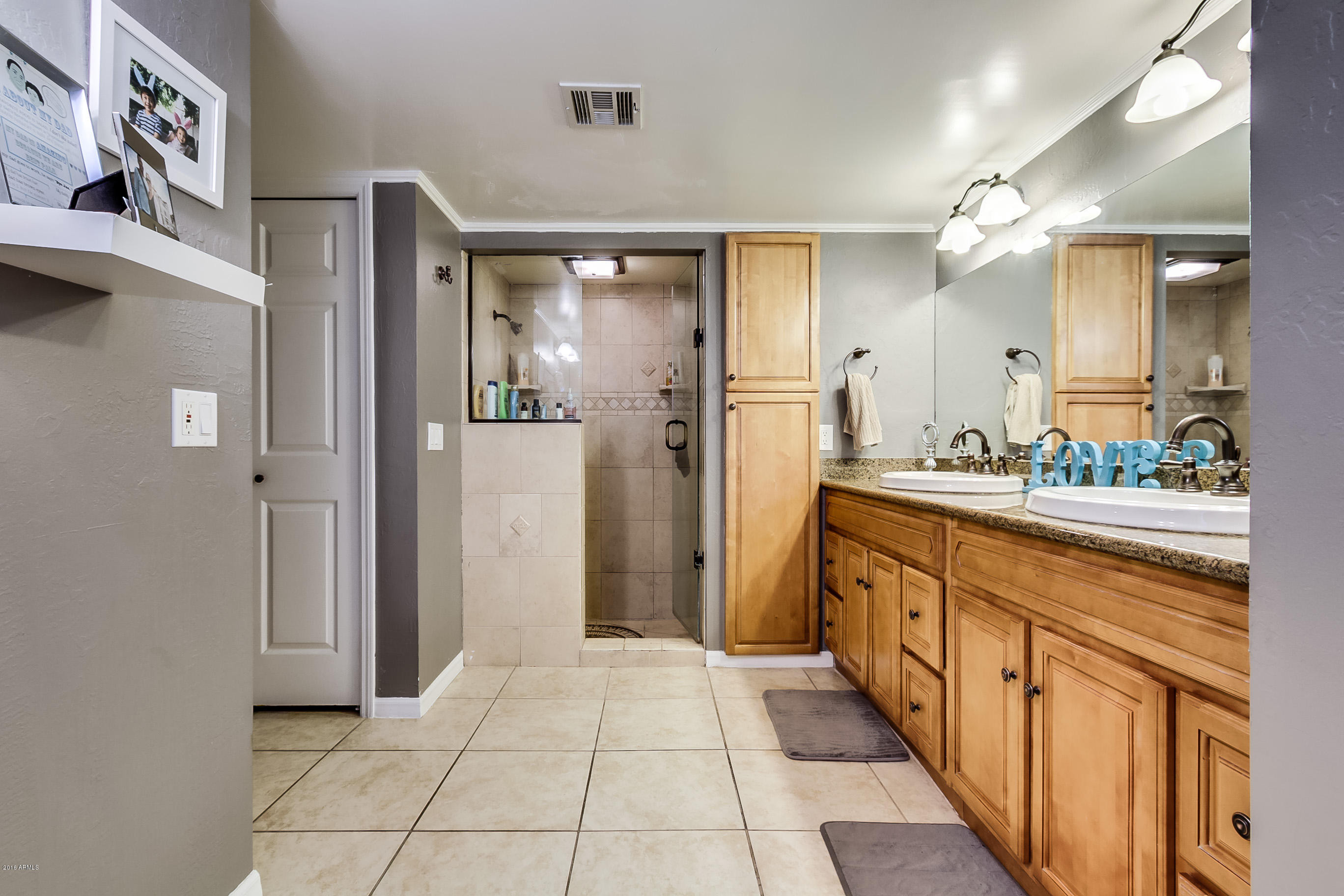 613 West Ocotillo Road Phoenix, AZ 85013 - Photo 5 of 18 a bathroom with a double vanity sink and a mirror