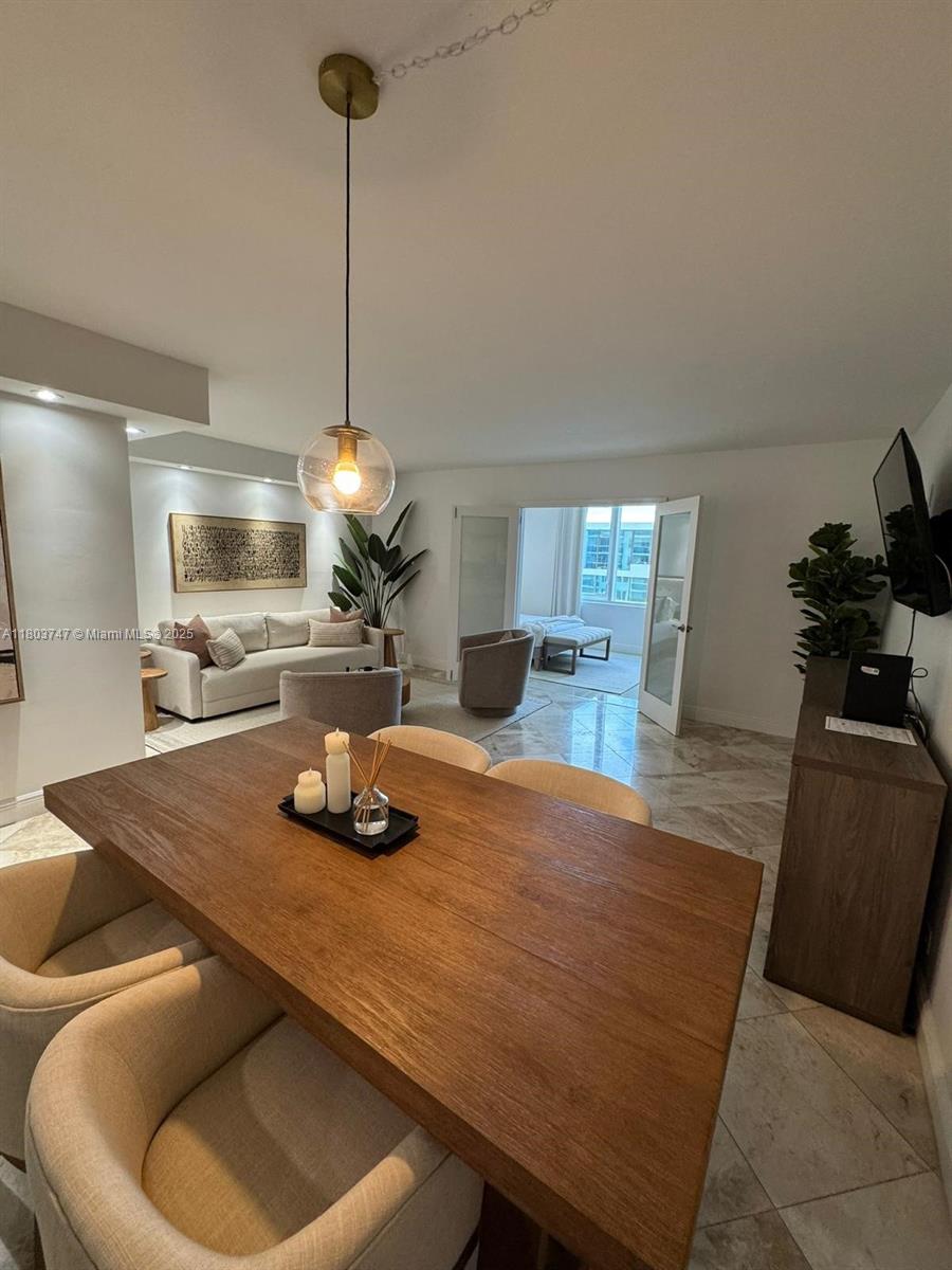 2301 Collins Avenue, Unit 731 Miami Beach, FL 33139 - Photo 14 of 31 a room with furniture and a chandelier