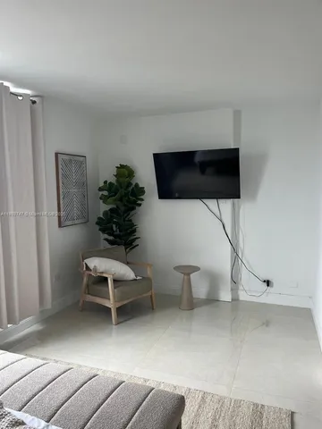 a living room with furniture a air conditioner and a window